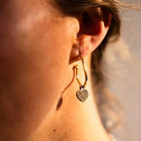 [modelwears Gold Maxi Cupid Hoop Earrings]