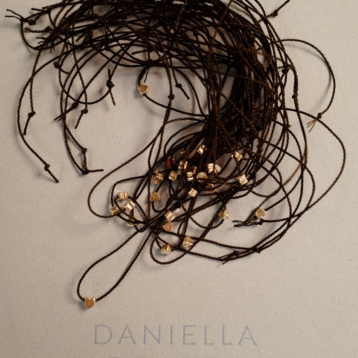 [winter] [badge Product Shown: Gold Tiny Heart Bracelet with Black Cord]
