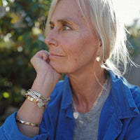 [modelwears Gold Tiny Cupid Hoop Earrings]