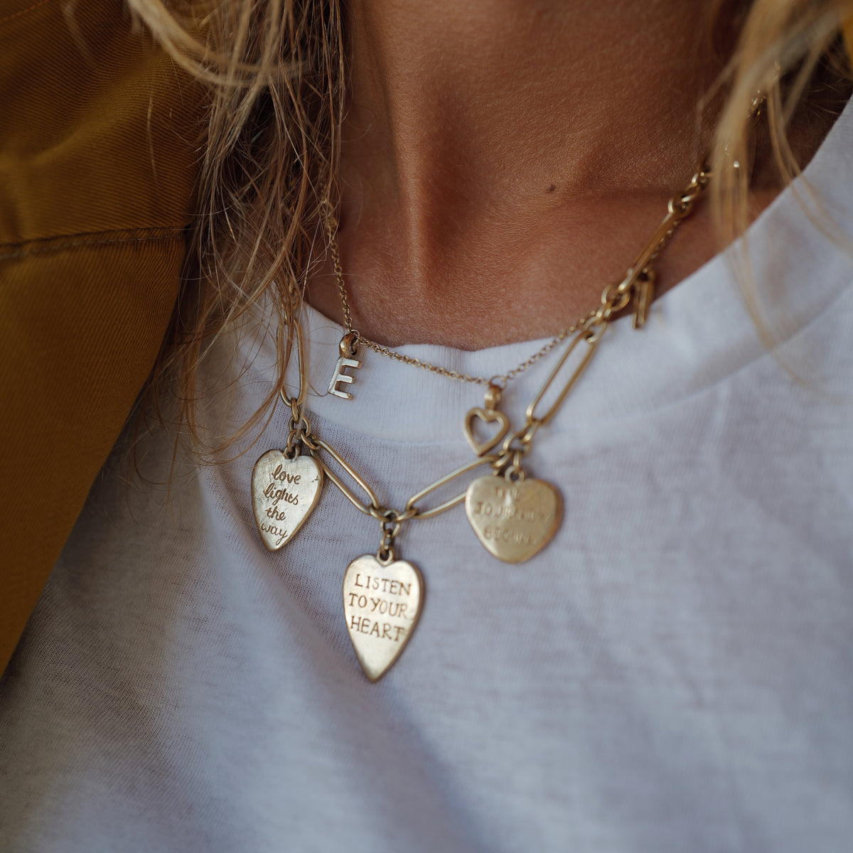 [modelwears Gold Trio Love Token Necklace with Gold Build Your Own Alphabet Necklace]