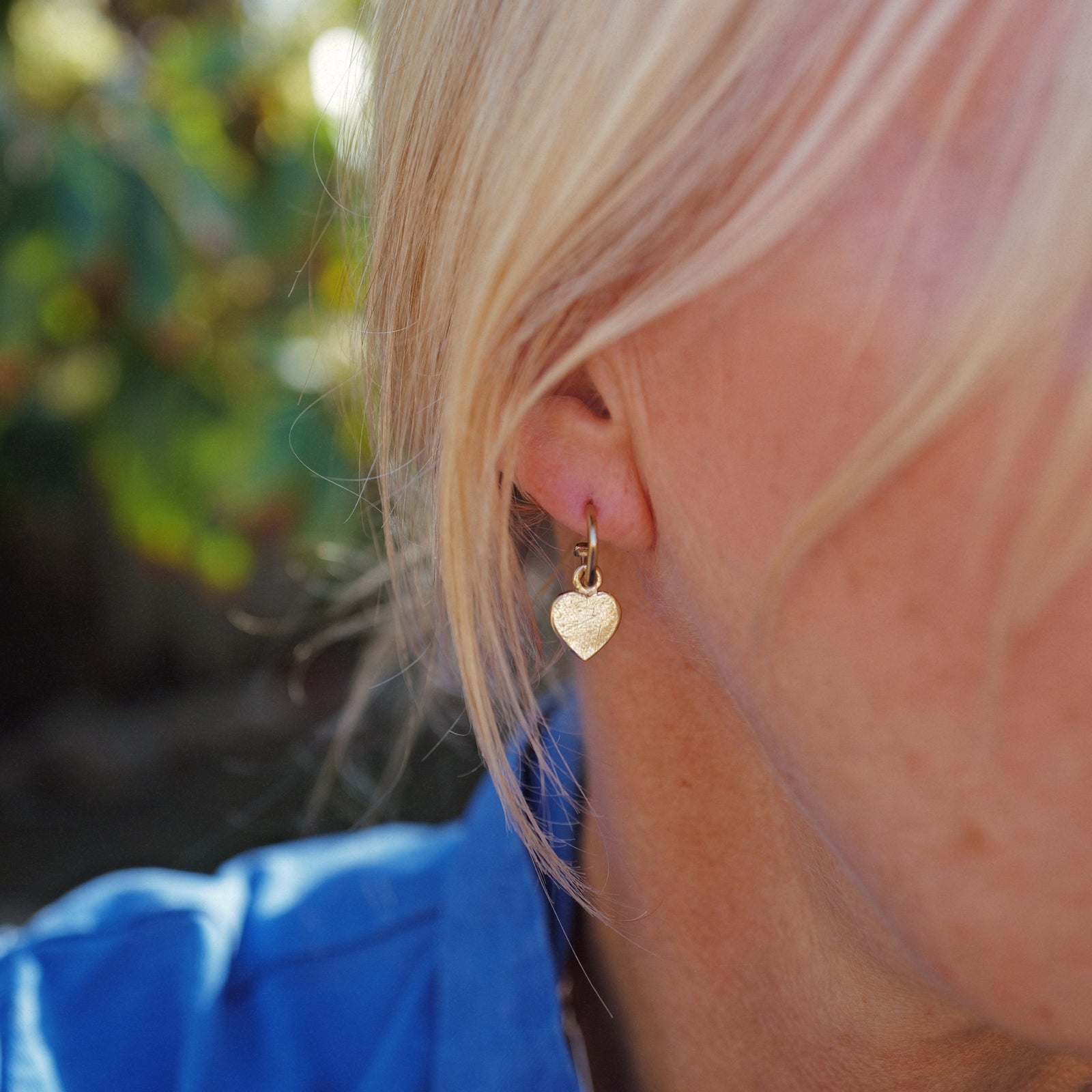[modelwears Gold Keeper's Heart Earring Charms on Tiny Cupid Hoops]