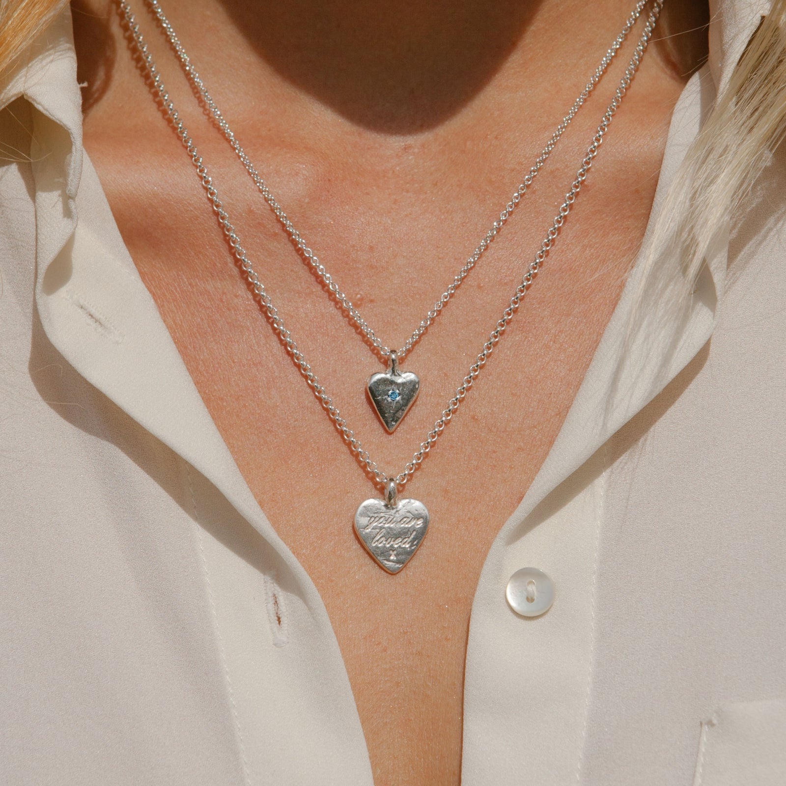 [modelwears Silver Mini Heart Necklace with Blue Topaz Stone]